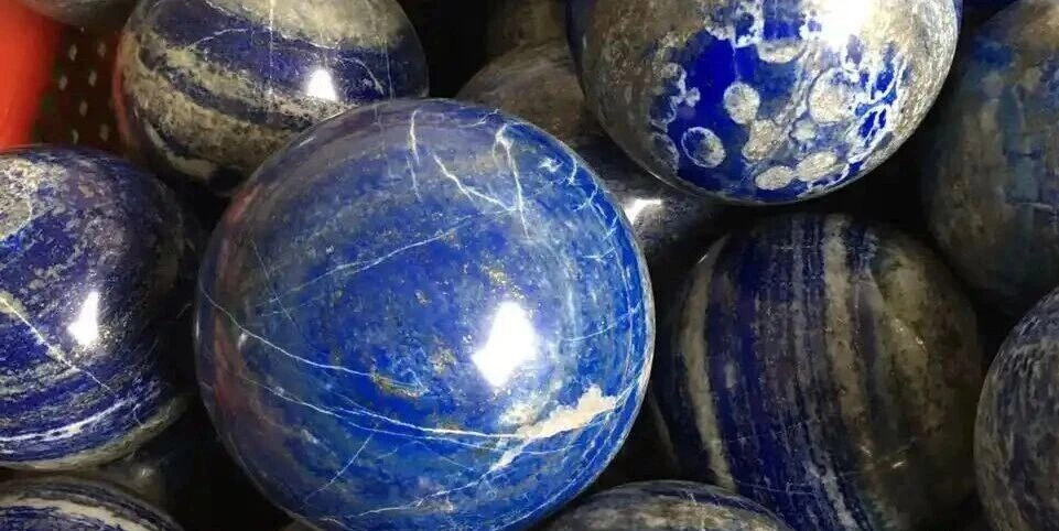 Polished blue lapis spheres with white and grey patterning