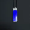 Full front view of rectangular blue lapis pendant on black cord