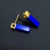 Side angle of rectangular blue lapis earrings with textured gold square tops