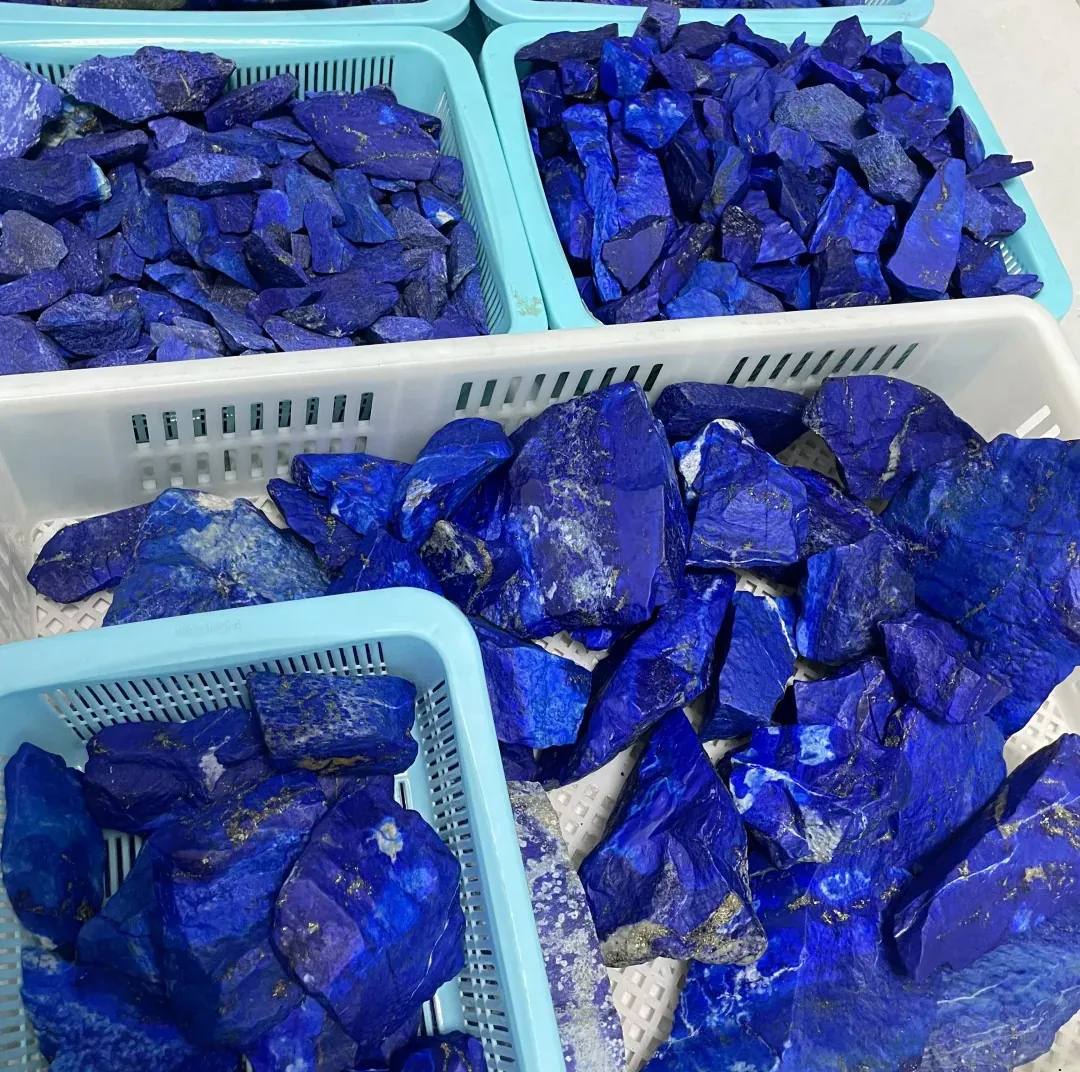 Trays filled with irregular rough lapis lazuli stones in varied blue shades