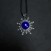 Round blue lapis lazuli cabochon centered in a silver sun pendant