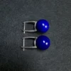 Angled round lapis lazuli earrings showing silver leverback posts