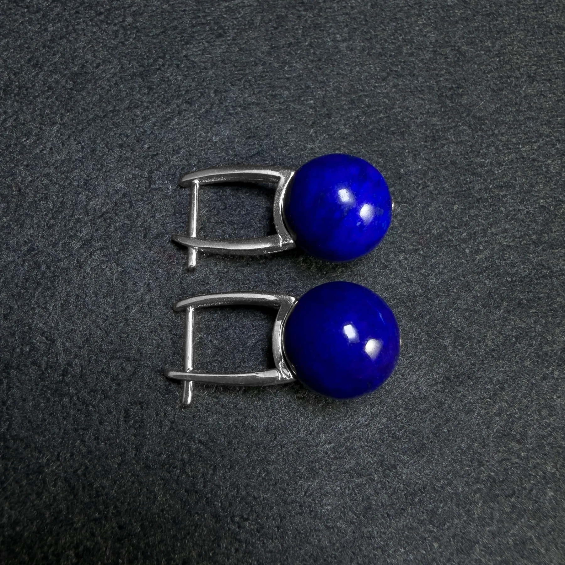 Angled round lapis lazuli earrings showing silver leverback posts