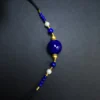 Diagonal royal-blue lapis necklace with pearls and black braided cord