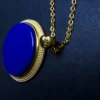 Macro view of S925 mark on gold-plated pendant bail beside chain