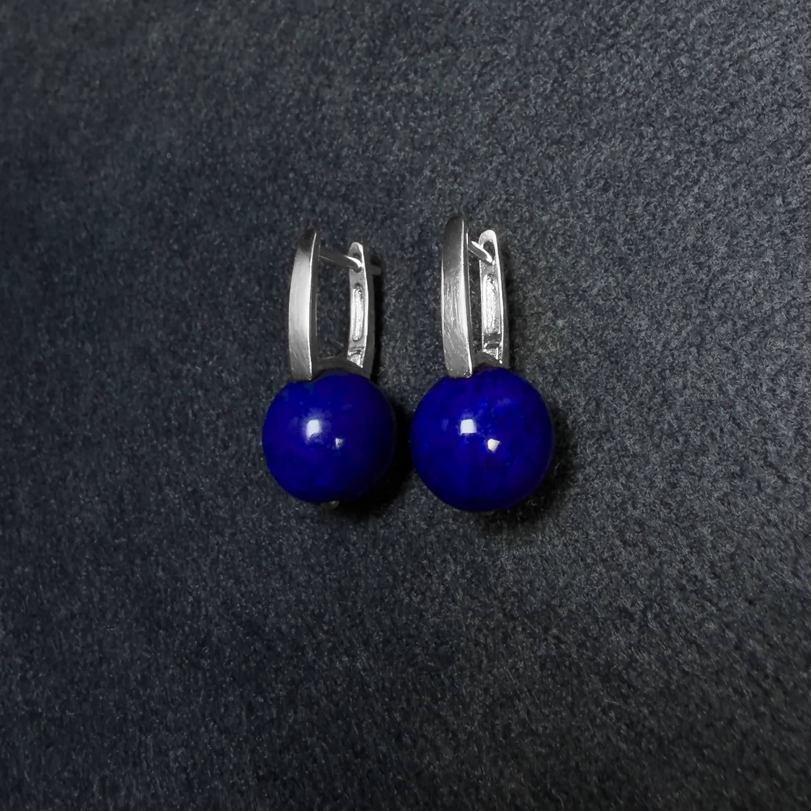 Upright silver leverback earrings with paired round lapis lazuli beads