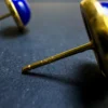 Macro detail of the S925 marking on a gold-tone earring post