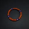 Wide view of Southern red agate bracelet with lapis and gold accents