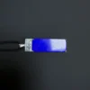 Horizontal lapis pendant detail with silver geometric setting and cord
