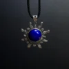 Sterling silver lapis lazuli sun pendant suspended on a black cord