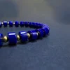 Side detail of polished straight-cut blue lapis beads on a stretch bracelet
