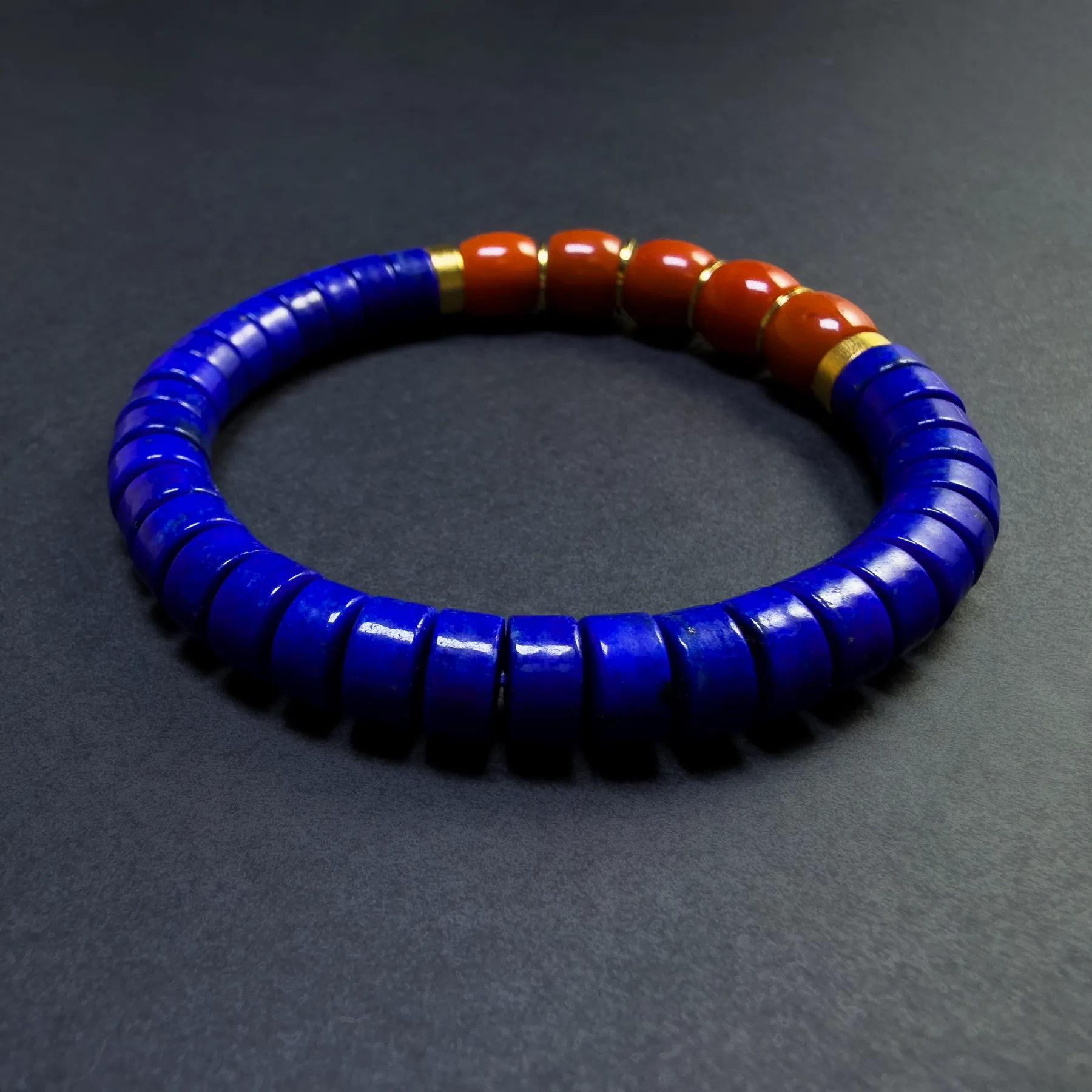 Low angle of straight-cut lapis beads and polished red agate accents
