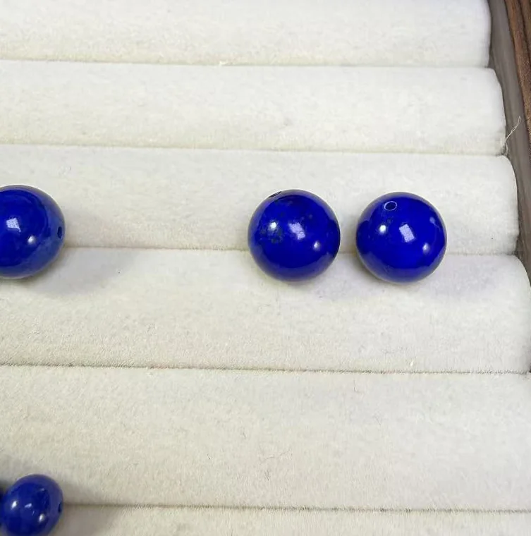 Polished deep blue lapis lazuli round beads after final finishing