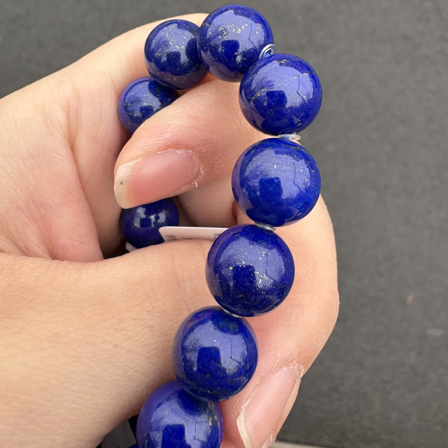 Natural lapis lazuli beads with dominant blue color, visible pyrite and little calcite