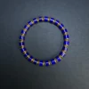 Geometric lapis lazuli bracelet arranged on a dark textured surface