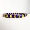 High quality lapis lazuli bracelet with blue cylinder beads and gold-toned accents