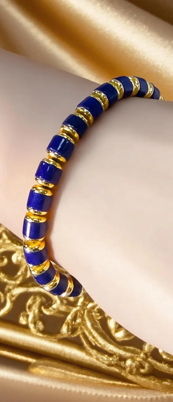Lapis lazuli cylinder bead bracelet with gold-tone spacers