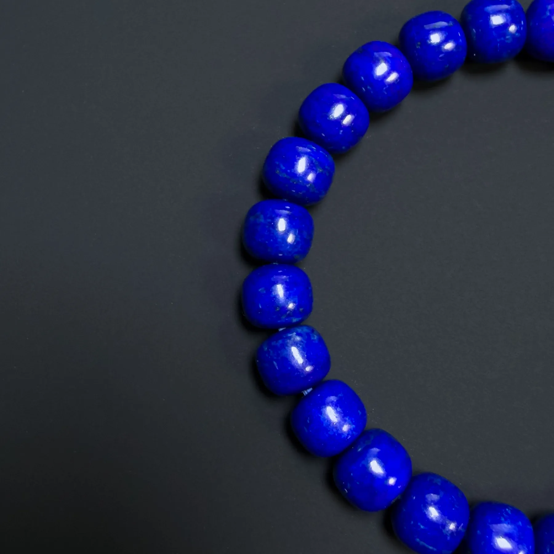 Close view of lapis beads with subtle gold-colored pyrite flecks