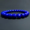 Low-angle view showing the bracelet's rounded barrel bead profiles