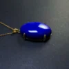 Angled oval lapis lazuli cabochon showing its domed profile
