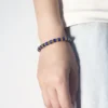 Blue lapis lazuli cylinder bead bracelet worn on the wrist