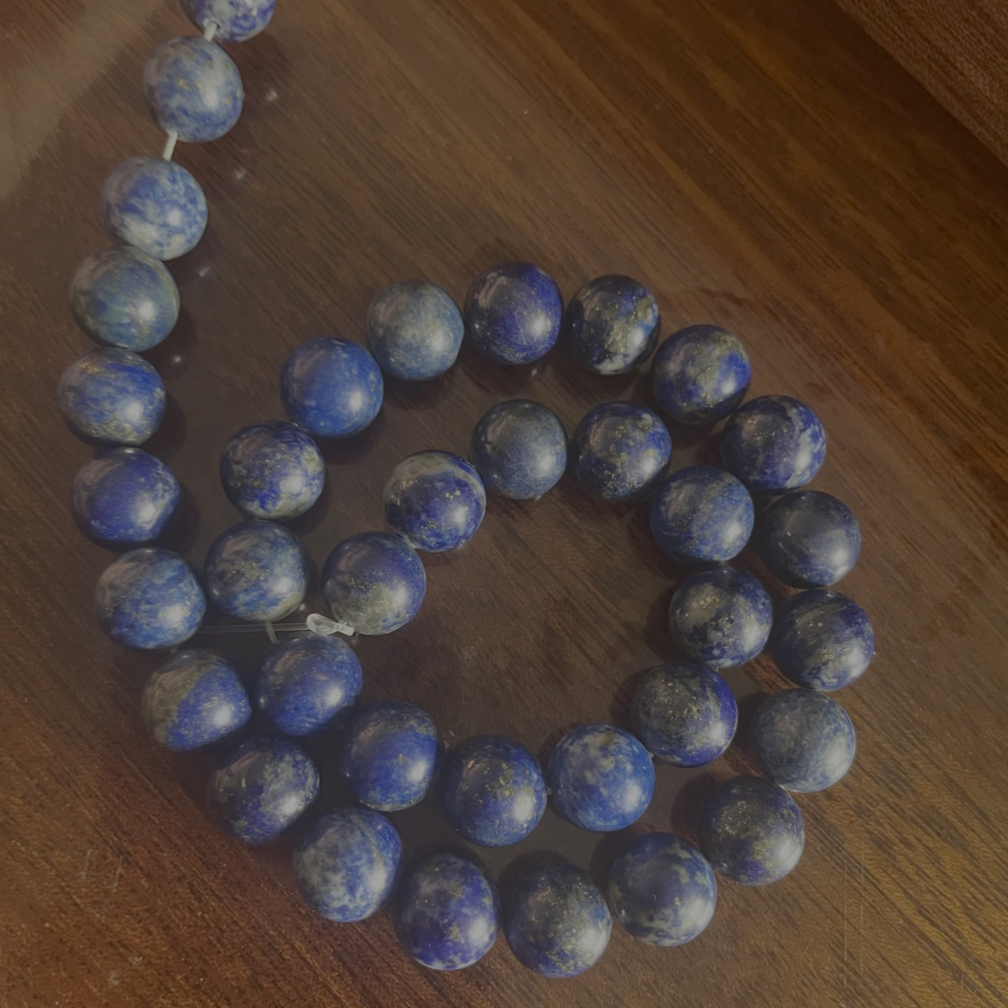 Low-grade lapis lazuli beads with heavy visible calcite and pyrite