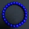 Close overhead view of natural lapis rounded barrel beads