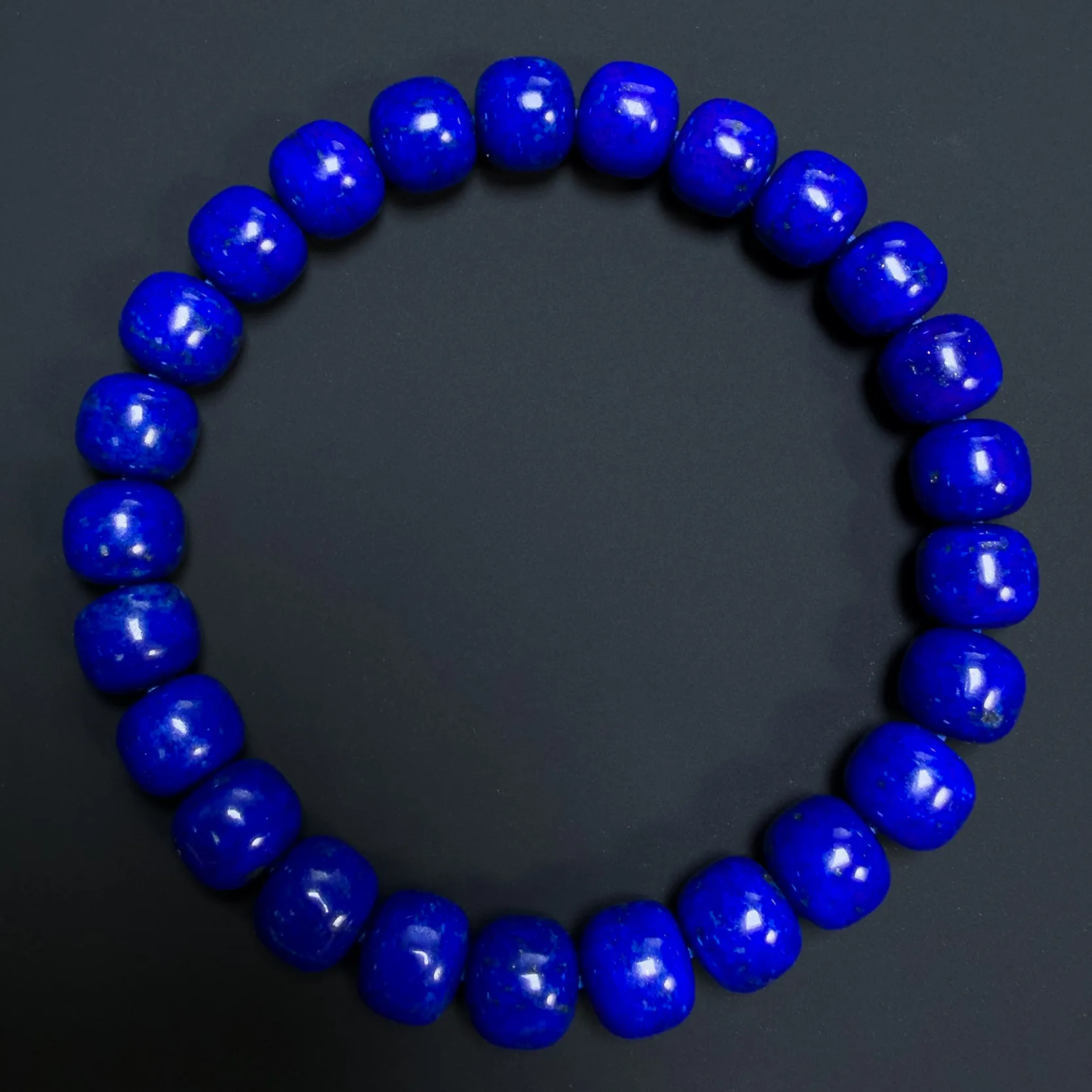 Close overhead view of natural lapis rounded barrel beads