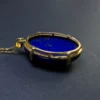 Rear view of oval lapis lazuli pendant in open silver setting