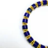 Close detail of polished blue cylinder beads and gold-toned spacers
