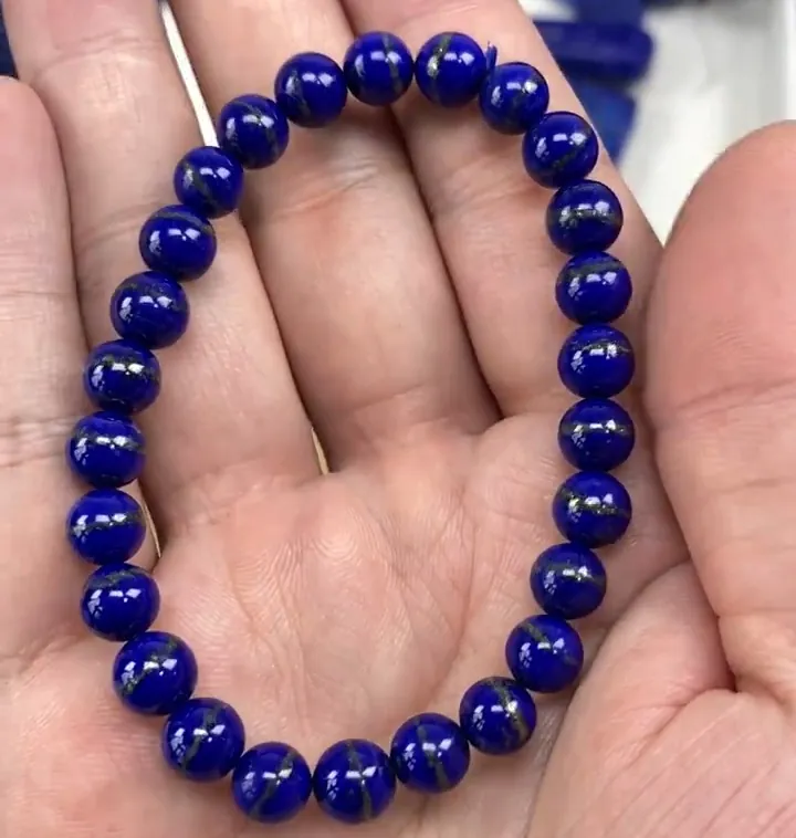 Blue lapis bracelet with visible metallic pyrite areas on several round beads