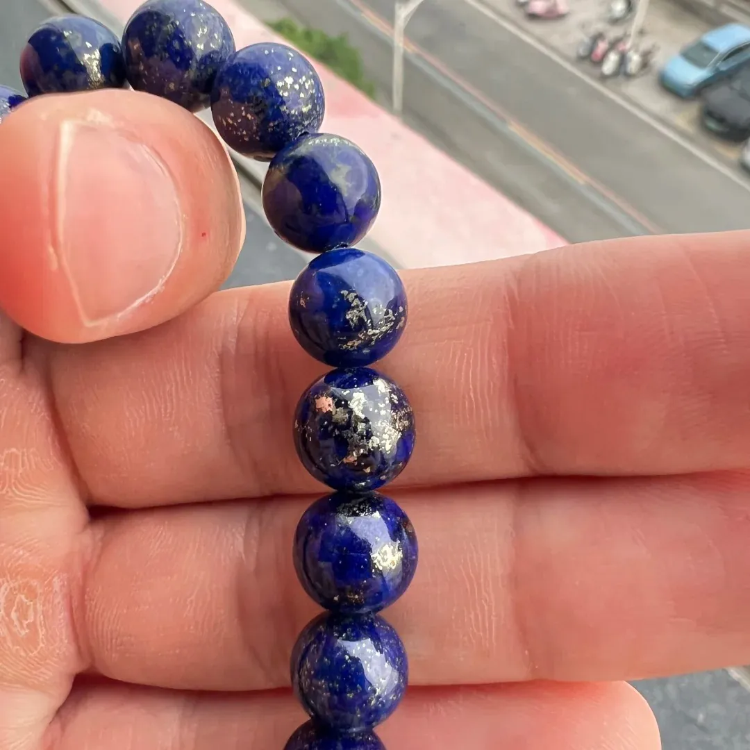 Close-up of lapis lazuli bracelet beads with fine flecks and larger pyrite patches