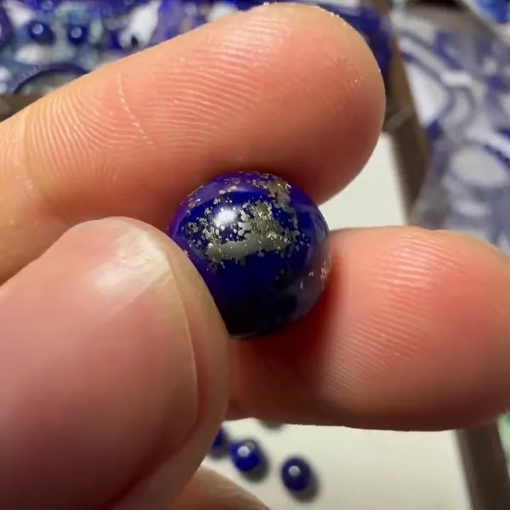 Close-up of lapis lazuli bead with a large metallic pyrite patch