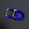 Angled pair of blue lapis bead earrings with their silver posts visible