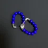 Overlapping lapis bead loops photographed from above with silver fittings in view