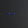 Five-stone lapis bracelet laid straight to show the chain, clasp and extension links