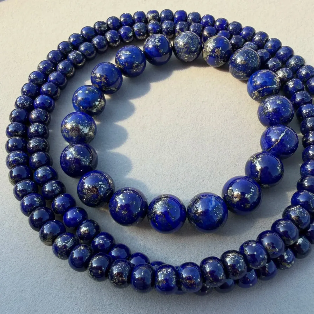 Lapis lazuli bead strands with dense visible pyrite across many beads
