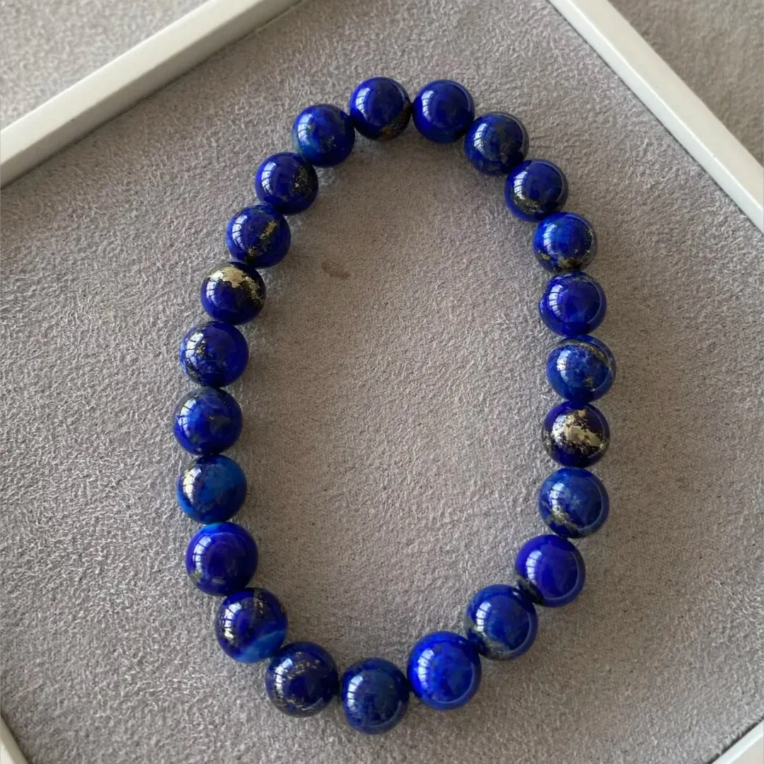 Round lapis lazuli bracelet showing mixed pyrite size and distribution across matched beads
