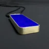 Close angled view of one end of the rectangular lapis pendant and its silver setting