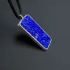 Reverse view of the rectangular lapis pendant with natural pale mineral patterning inside the silver frame