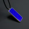 Main view of a royal-blue rectangular lapis lazuli pendant in a silver bezel with black cord